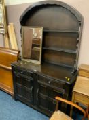 A dark oak priory style arched dresser