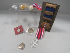 A quantity of medals and badges