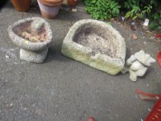 A sandstone trough together with a concrete frog and a bird bath