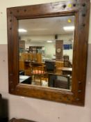 A modern rectangular colonial star wall mirror with metal studded detail