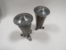 A PAIR OF ARTS AND CRAFTS SILVER PEPPERS BY A.E. JONES H.M. BIRMINGHAM 1906