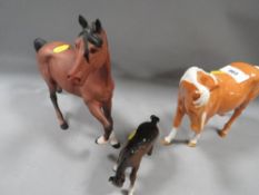 A Beswick Spirit horse figure in bay matt finish, a Beswick Palomino figure A/F and a grazing foal