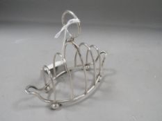 A hallmarked silver wire work four division toast rack