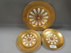 Two Aynsley heavily gilded plates and a saucer with hand painted fruit design