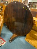 An antique rosewood tilt top circular center table A/F H 66.5 cm Dia. 122 cm