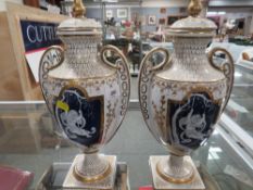 A pair of reproduction gilded white style pate sur pate lidded urns