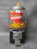 A VINTAGE STYLE METAL AND PLASTIC GUMBALL MACHINE, (currently containing Skittles), complete with