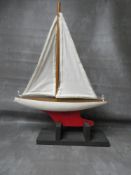 A VINTAGE POND YACHT AND STAND