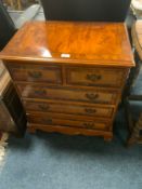 A small reproduction five drawer chest