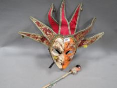 A Venetian carnival mask together with ceramic dolls head on a stick (2)