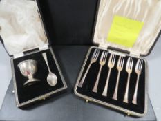 A cased hallmarked silver egg cup & spoon gift set together with a cased set of hallmarked silver