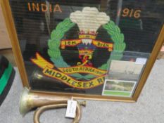 A WW1 framed and glazed embroidery for the Middlesex regiment, dated 1916, plus a WW1 German bugle