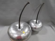 Two large decorative silver cherries