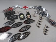 A collection of assorted Morgan car related badges, pins, keyrings and walking stick emblems etc