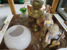 A pair of Continental style figures, brass oil lamp etc