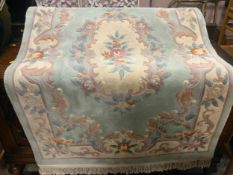 A large woolen Chinese rug 186 x 123 cm