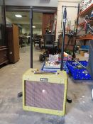 A Tokai TA-35-OC Tweed amp with two microphone stands