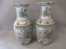 A pair of Oriental style famille rose style vases (both badly damaged)