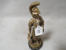 A cast metal statuette in the form of a Roman lady