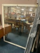 A large wooden framed wall mirror 140 x 122 cm