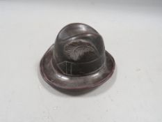 A vintage black forest style inkwell in the shape of a Tyrolean hat