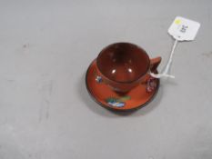 A Wedgwood mini terracotta cup and saucer