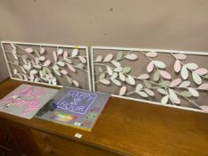 Two neon signs together with a pair of metal wall hangings