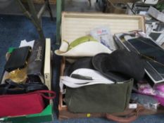 A vintage suitcase containing hats, bags and accessories