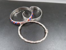 A modern silver and enamel hinged bangle, stamped 925, together with two additional 925 silver