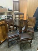 A vintage oak draw leaf table and four chairs