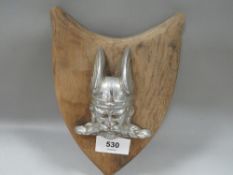 A vintage Rover Viking car badge mounted on wooden shield