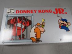 A vintage Nintendo Donkey Kong JR hand held game and watch DJ-101 1982 in original box