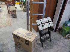 A set of ladders together with a workbench and boxed stepper - contents unchecked