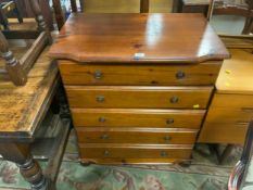 A honey pine five drawer chest