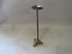 A gilt metal wig stand