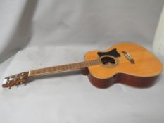 A Tanglewood hand-crafted acoustic guitar with mother of pearl inlaid fret markers model number TW-
