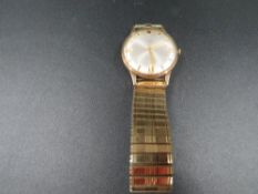 A 9 carat gold Avia wrist watch on expandable steel bracelet