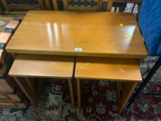 A mid-century teak nest of tables