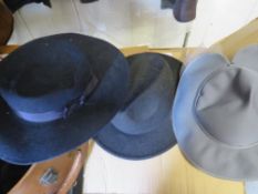 A vintage hat box containing various hats