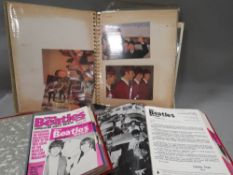 Three folders of Beatles memorabilia to include postcards, magazines etc