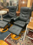 A pair of modern black massage chairs A/F with missing cables