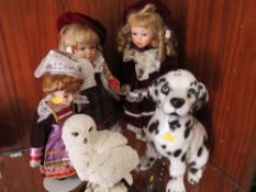 A model of a snowy owl together with a ceramic Dalmatian puppy and three collectable dolls