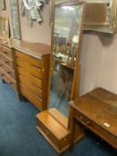 A modern cheval mirror with drawer