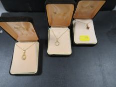 Three assorted gold pendants