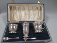 A cased hallmarked silver three piece cruet set