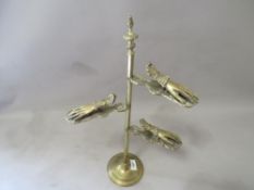 An unusual brass three tier hand-clip stand