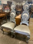 A large pair of modern silver throne chairs