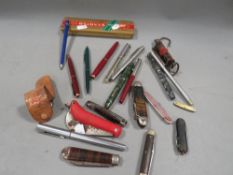 A tray of collectables to include penknife's and pens
