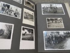 A German WW2 photograph album 'WEHRDIENST EHRENDIENST' containing approx 83 photos together with