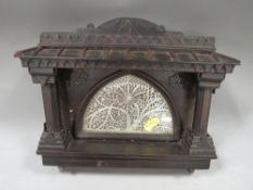 An antique Indian household shrine, a white metal fretwork backplate with carved wood surround